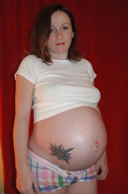 Young pregnant woman in her bedroom