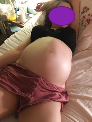 Big breasts and big belly of pregnant woman