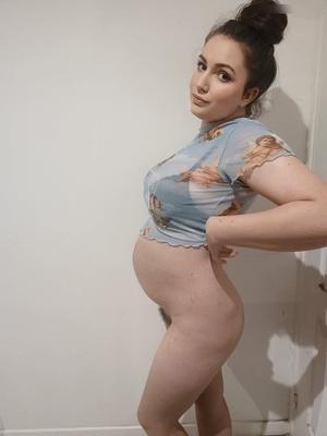 Young French pregnant woman showing her body